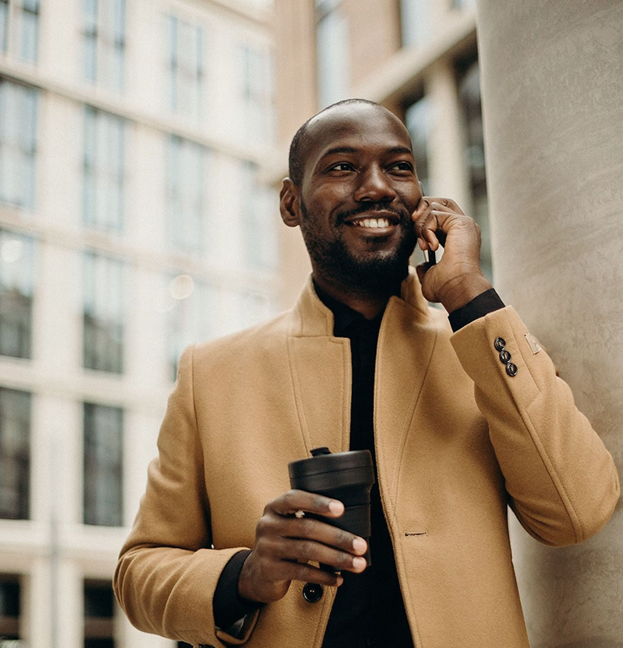 Smiling man with mobile phone to ear